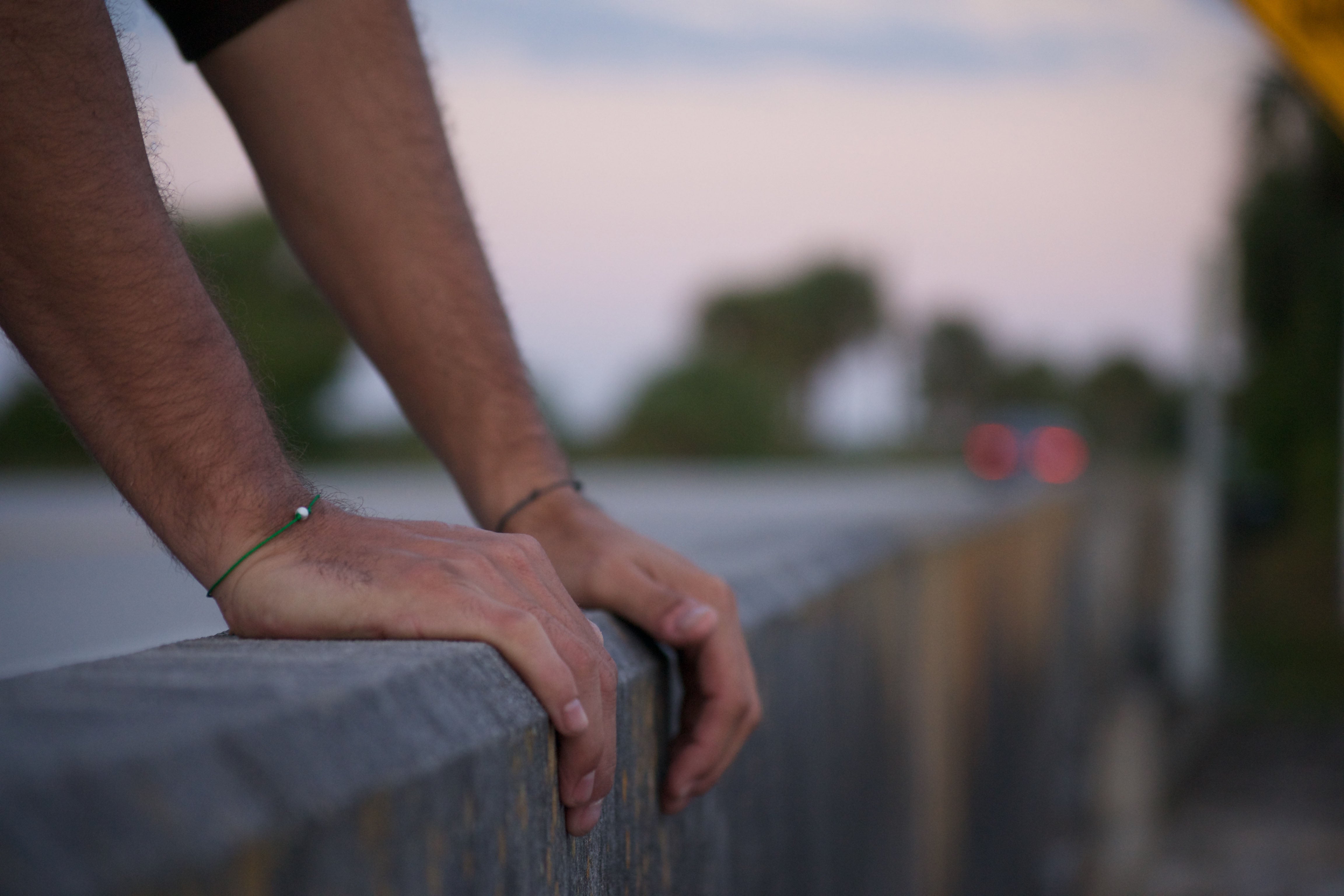 Modeled Love Hope Friendship Bracelet with, blurred, scenic background of a road